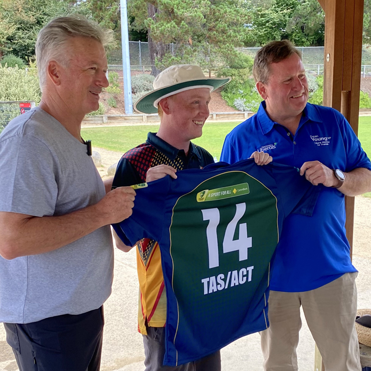 Dylan Gangell being presented his TAS/ACT NCIC player's top by Steve Waugh and Dean Young MP