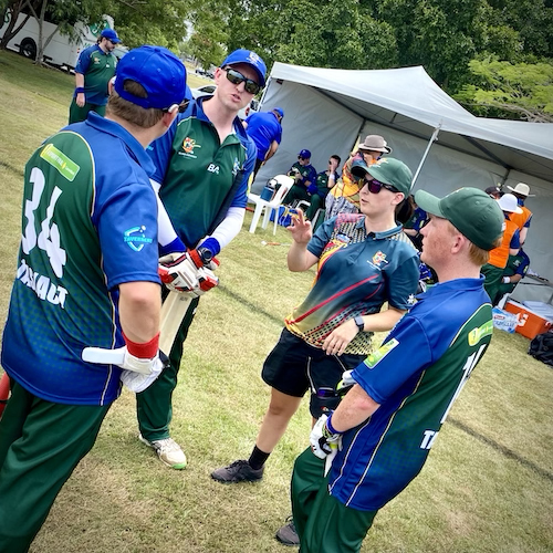 Coach Taylah Purton talks game tactics with Captain Michael Hamilton and some TAS/ACT CATS players