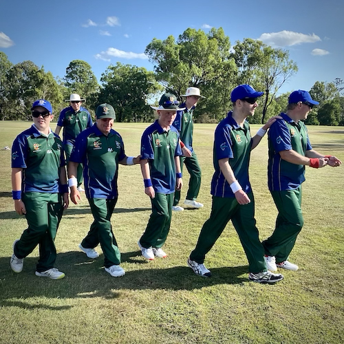 Group of TAS/ACT CATS players walking off the ground after fielding