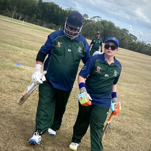 Toby Hartshorn (B3) assists Ben Phillips (B1) off the ground after batting