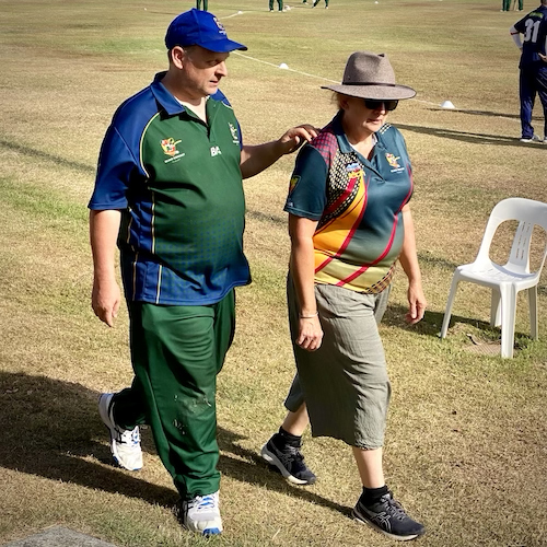 Mobility and orientation specialist Elsa Wrighton assisting blind player Ben Phillips back to the team tent