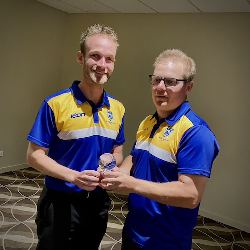 Mathew Kent (B2) and teammate Daniel Searle (B1) standing together holding their trophies for being awarded best B1 and best B2 players of the tournament