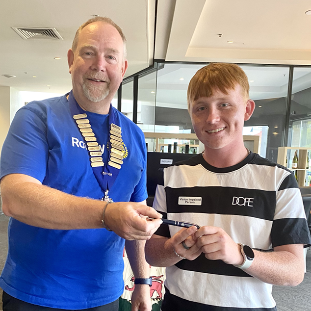 Dylan Gangell being presented a Rotary Club pen from Hobart branch President Matt Drake after being a guest at a Club lunch