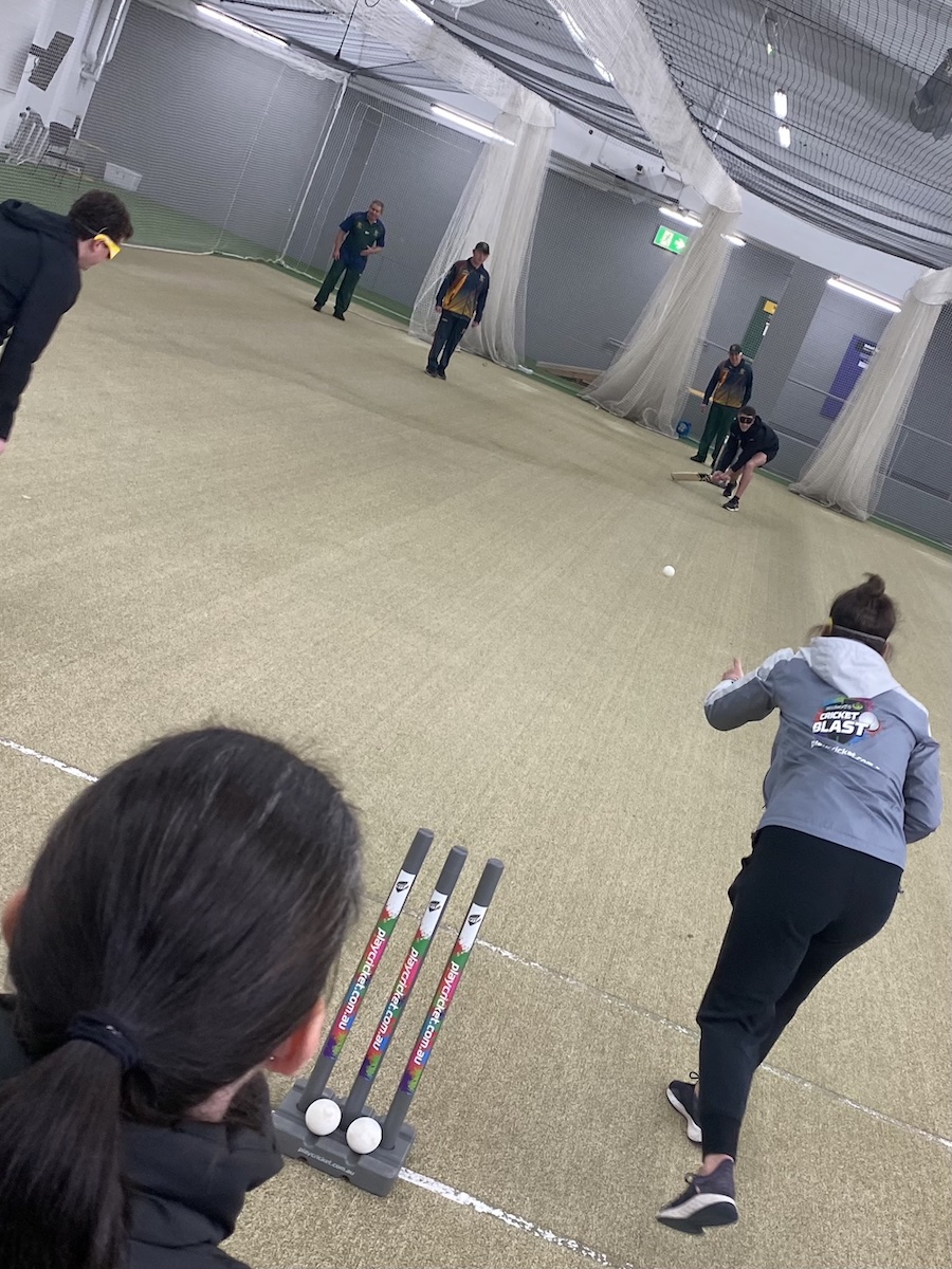 Cricket Tasmania staff member bowling at the BCT training session