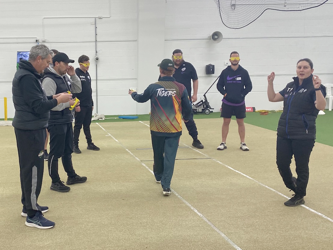 Tas Tiger player teaching Cricket Tasmania staff to play blind cricket